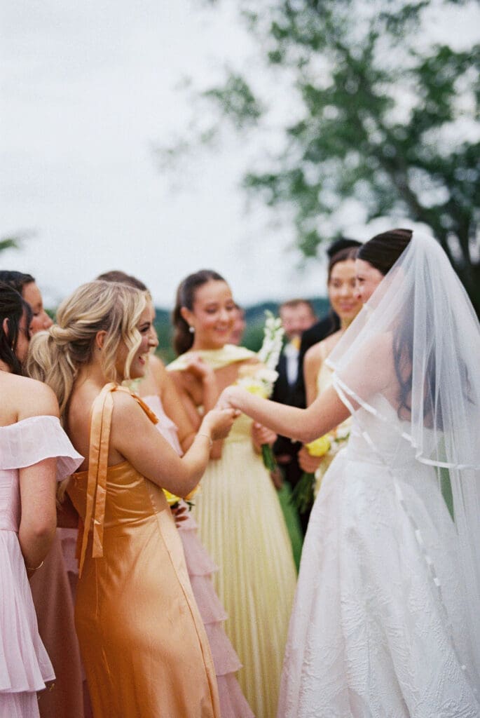 film vs digital wedding photography. bride showing off ring to her bridesmaids photographed on film in knoxville tennessee.