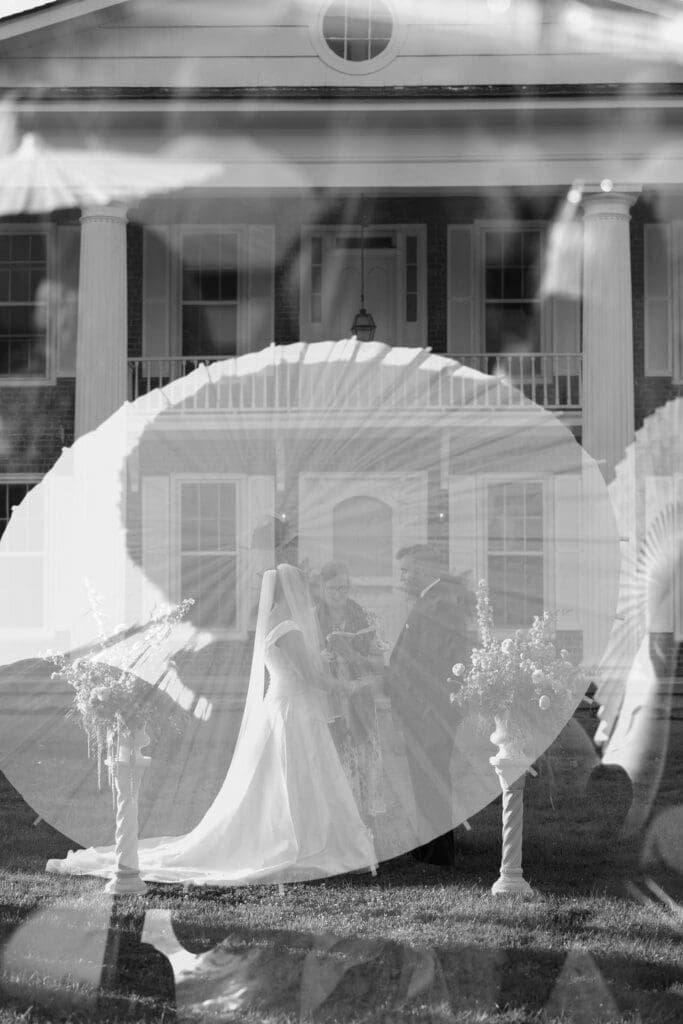 black and white timeless double exposure of umbrella detail and bride and groom holding hands at the alter