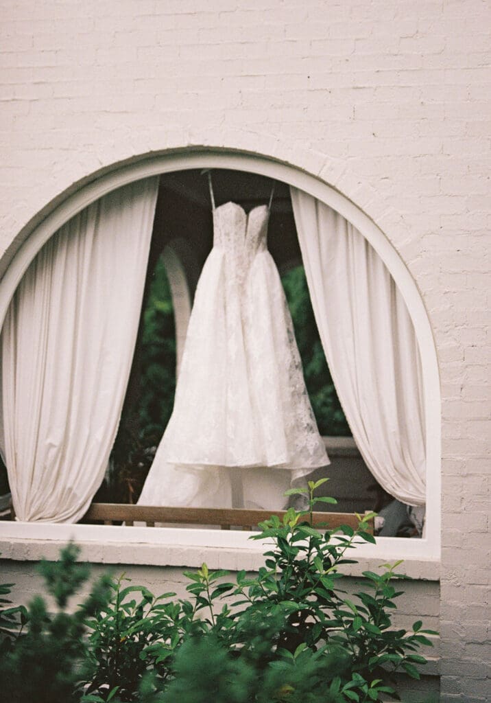 knoxville bride wedding gown hanging in arched classic window